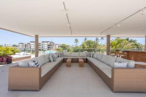 a living room with a couch on a roof at Malia Muro Alto - Porto de Galinhas - Flat para 5 pessoas vista piscinas in Ipojuca