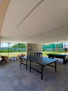 a large room with two ping pong tables in it at Malia Muro Alto - Porto de Galinhas - Flat para 5 pessoas vista piscinas in Ipojuca