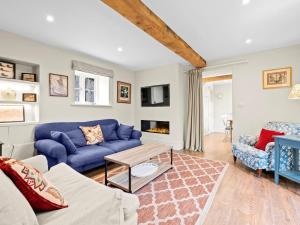 a living room with a blue couch and a fireplace at 2 Bed in Ludlow oc-83363 in Hopton Cangeford