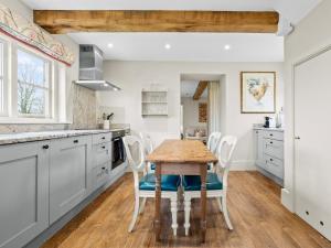 a kitchen with a wooden table and chairs at 2 Bed in Ludlow oc-83363 in Hopton Cangeford