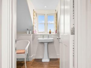 a white bathroom with a sink and a window at 2 Bed in Ludlow oc-83363 in Hopton Cangeford +15 photos
