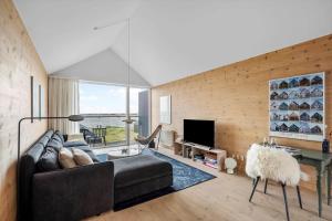 a living room with a couch and a tv at 733-Hvide-Sande-Slusen-33 in Hvide Sande
