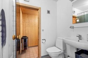 a bathroom with a toilet and a sink at 733-Hvide-Sande-Slusen-33 in Hvide Sande +30 photos