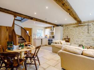 a living room with a couch and a table at 2 Bed in Bridport oc-dc081 in Loders