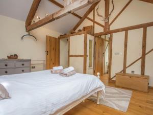 a bedroom with a large white bed with towels on it at 2 Bed in Bridport oc-dc081 in Loders