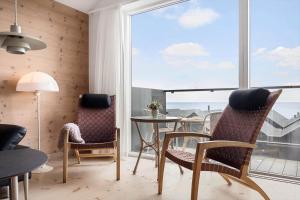 a room with a table and chairs and a large window at 727-Hvide-Sande-Slusen-27 in Hvide Sande