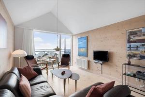 a living room with a couch and a table at 727-Hvide-Sande-Slusen-27 in Hvide Sande