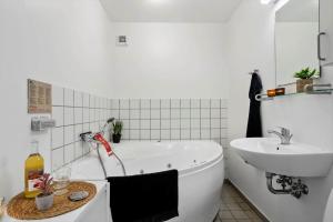 a white bathroom with a tub and a sink at 727-Hvide-Sande-Slusen-27 in Hvide Sande +38 photos