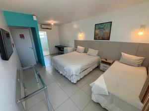 a hotel room with two beds and a table at Village Hotel Belém in Belém de São Francisco +21 photos