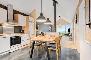 a kitchen and dining room with a table and chairs at 701-Hvide-Sande-Slusen-1 in Hvide Sande