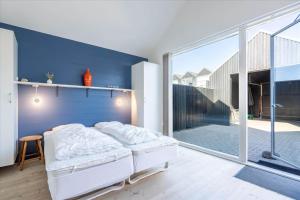 a bedroom with a bed and a large window at 705-Hvide-Sande-Slusen-5 in Hvide Sande