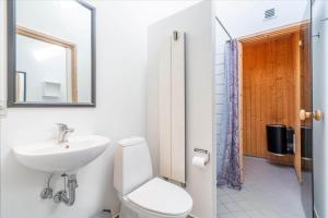 a bathroom with a toilet and a sink and a mirror at 705-Hvide-Sande-Slusen-5 in Hvide Sande +20 photos