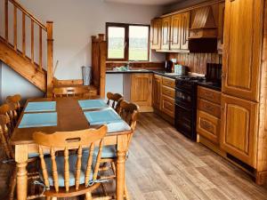 a kitchen with a wooden table and wooden cabinets at Fisherman Lodge No 2 in Enniskillen +6 photos
