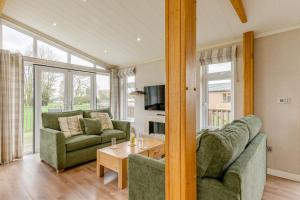 a living room with two couches and a table at Primrose 2 bed - Violet in Eye