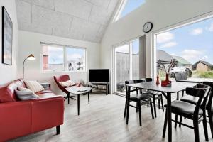 a living room with a red couch and a table at 941-Hvide-Sande-Langsand-167 in Hvide Sande