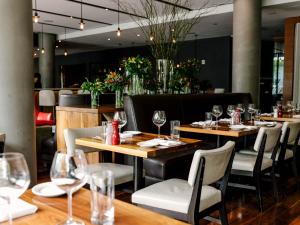 a restaurant with wooden tables and chairs and wine glasses at The Study at Yale in New Haven