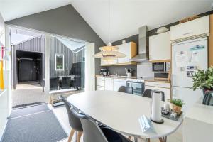 a kitchen and dining room with a table and chairs at 706-Hvide-Sande-Slusen-6 in Hvide Sande