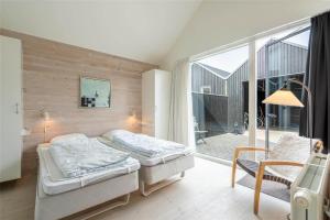 a bedroom with two beds and a balcony at 706-Hvide-Sande-Slusen-6 in Hvide Sande