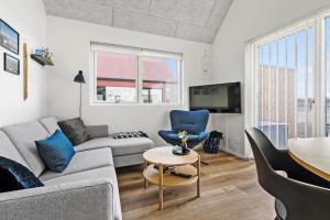 a living room with a couch and a table at 948-Hvide-Sande-Langsand-226 in Hvide Sande