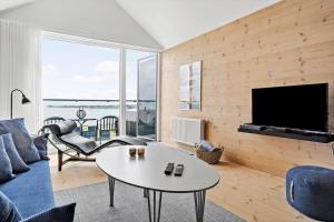 a living room with a couch and a table at 723-Hvide-Sande-Slusen-23 in Hvide Sande