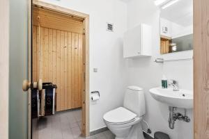 a white bathroom with a toilet and a sink at 723-Hvide-Sande-Slusen-23 in Hvide Sande +30 photos