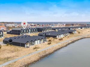an aerial view of a row of houses next to the water at 723-Hvide-Sande-Slusen-23 in Hvide Sande
