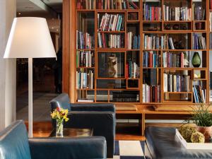 a living room with a book shelf filled with books at The Study at Yale in New Haven