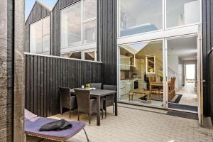 a balcony with a table and chairs on a building at 722-Hvide-Sande-Slusen-22 in Hvide Sande
