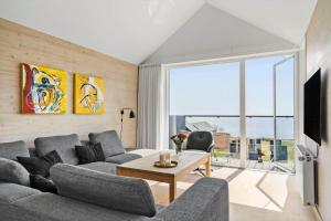a living room with a couch and a tv at 722-Hvide-Sande-Slusen-22 in Hvide Sande