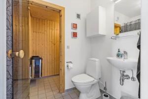 a bathroom with a toilet and a sink at 722-Hvide-Sande-Slusen-22 in Hvide Sande +32 photos