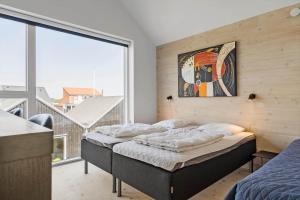 a bedroom with two beds and a large window at 722-Hvide-Sande-Slusen-22 in Hvide Sande