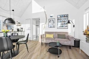 a living room with a couch and a table at 946-Hvide-Sande-Langsand-224 in Hvide Sande
