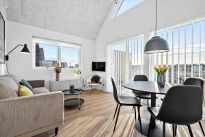 a living room with a table and a couch at 946-Hvide-Sande-Langsand-224 in Hvide Sande