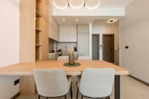 a kitchen and dining room with a wooden table and chairs at SeaLine Residence in Bar