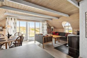 a living room with a couch and a dining room at 505-Hvide-Sande-Riskrogvej-12 in Havrvig