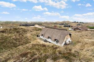 an old house sitting in the middle of a field at 505-Hvide-Sande-Riskrogvej-12 in Havrvig +28 photos