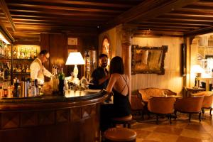 a group of people sitting at a bar at Danieli, Venezia, A Four Seasons Hotel in Venice