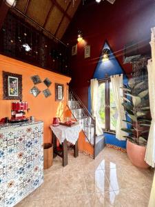 a room with a staircase and a table and a window at Backpackers Cabin with Mountain View in Bedugul