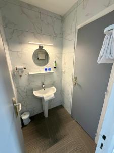 a bathroom with a sink and a mirror at La Marinière Hôtel Restaurant in Saint Malo +47 photos