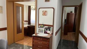 a bathroom with a sink and a mirror at Kőnig apartman in Hévíz +24 photos