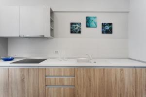 a kitchen with a sink and a counter top at Athina Suites Hotel in Bucharest +42 photos