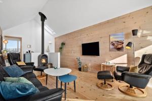 a living room with a couch and chairs and a tv at 7716-Hvide-Sande-Slusen-16 in Hvide Sande