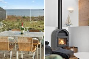 a dining room with a table and a fireplace at 7716-Hvide-Sande-Slusen-16 in Hvide Sande
