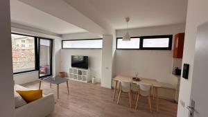 a living room with a couch and a table at Warm apartament 3 in Bucharest