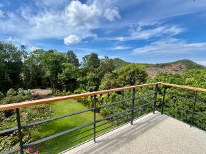 a balcony with a view of the mountains at Titine Apartment in Srithanu