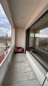 a balcony of a building with two beds on it at Warm apartament 3 in Bucharest