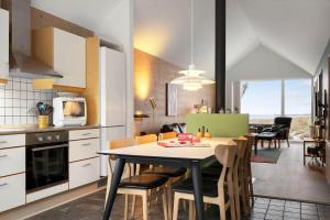 a kitchen and dining room with a table and chairs at 745-Hvide-Sande-Slusen-45 in Hvide Sande