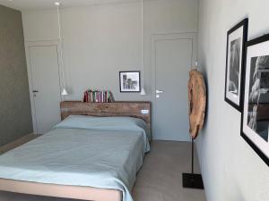 a bedroom with a bed and two white doors at PECORANERA in Bracciano +97 photos