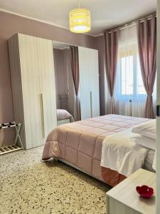 a bedroom with a large bed and a window at A due passi dalla Certosa in Certosa di Pavia