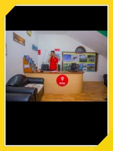 a man standing at a counter in a store at Hotel Bien Venue in Pokhara